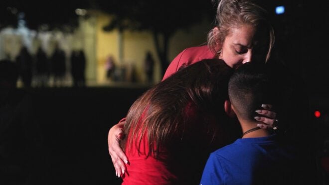 Families hug outside the Willie de Leon Civic Center where grief counseling will be offered in Uvalde