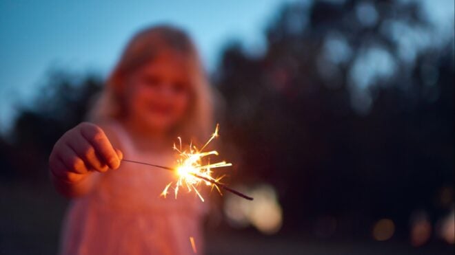 Kid holding a sparkler