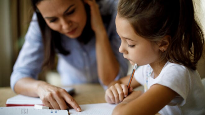 mom helping daughter with homework