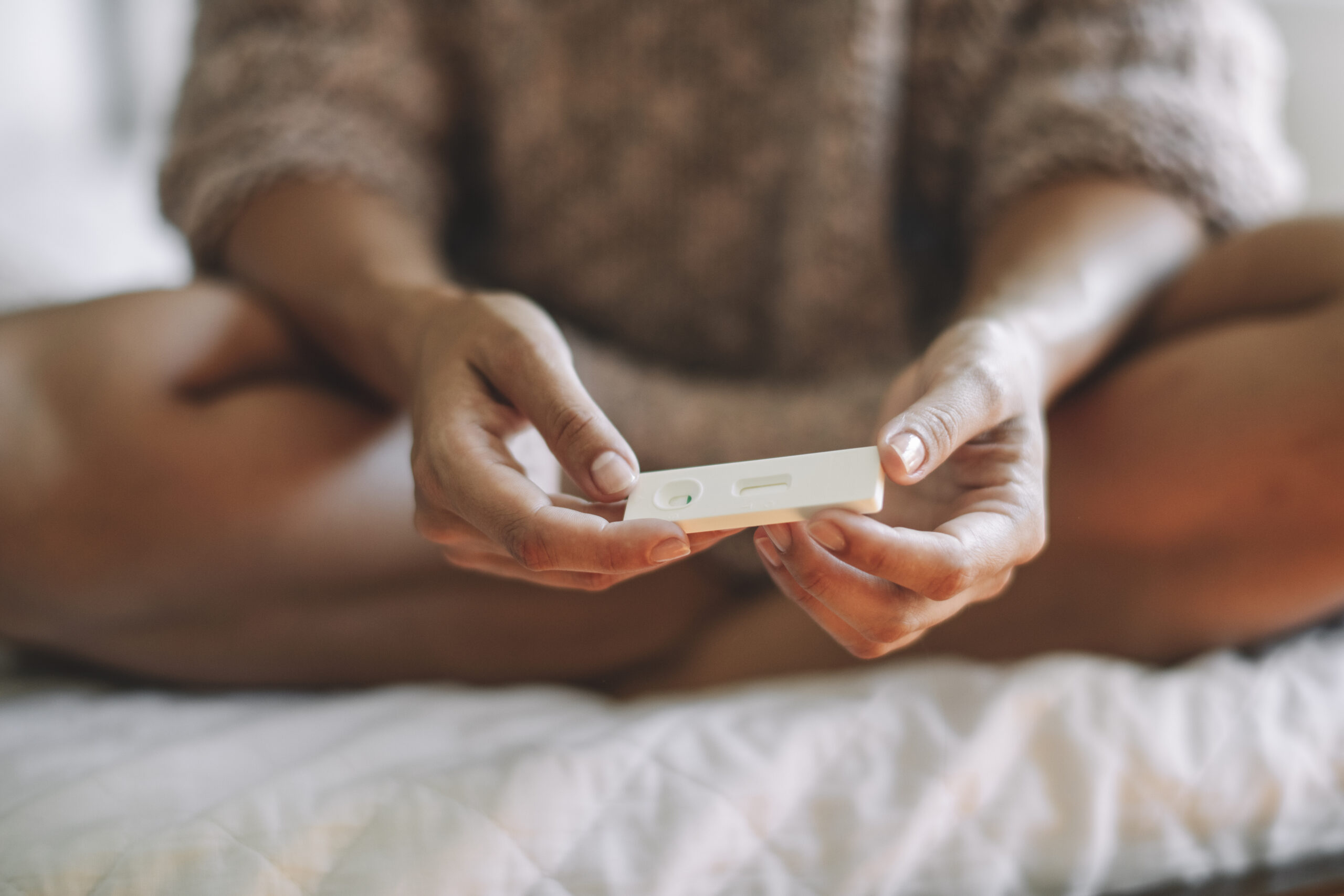 woman holding pregnancy test