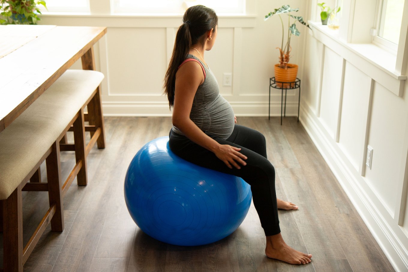 Pregnant person on an exercise ball