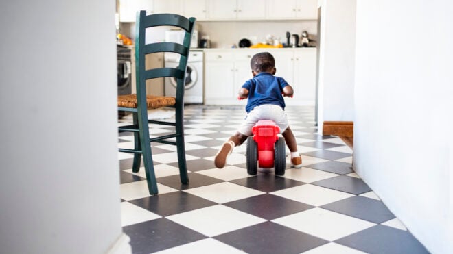 A kid riding on a toy