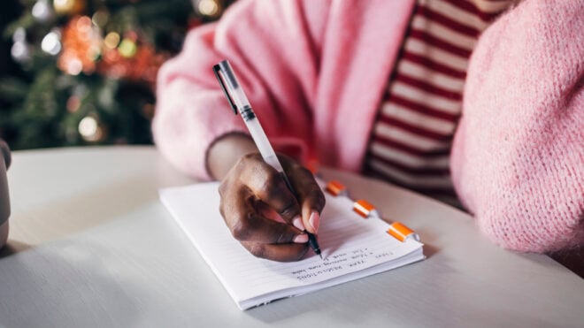 A woman writing in a notepad