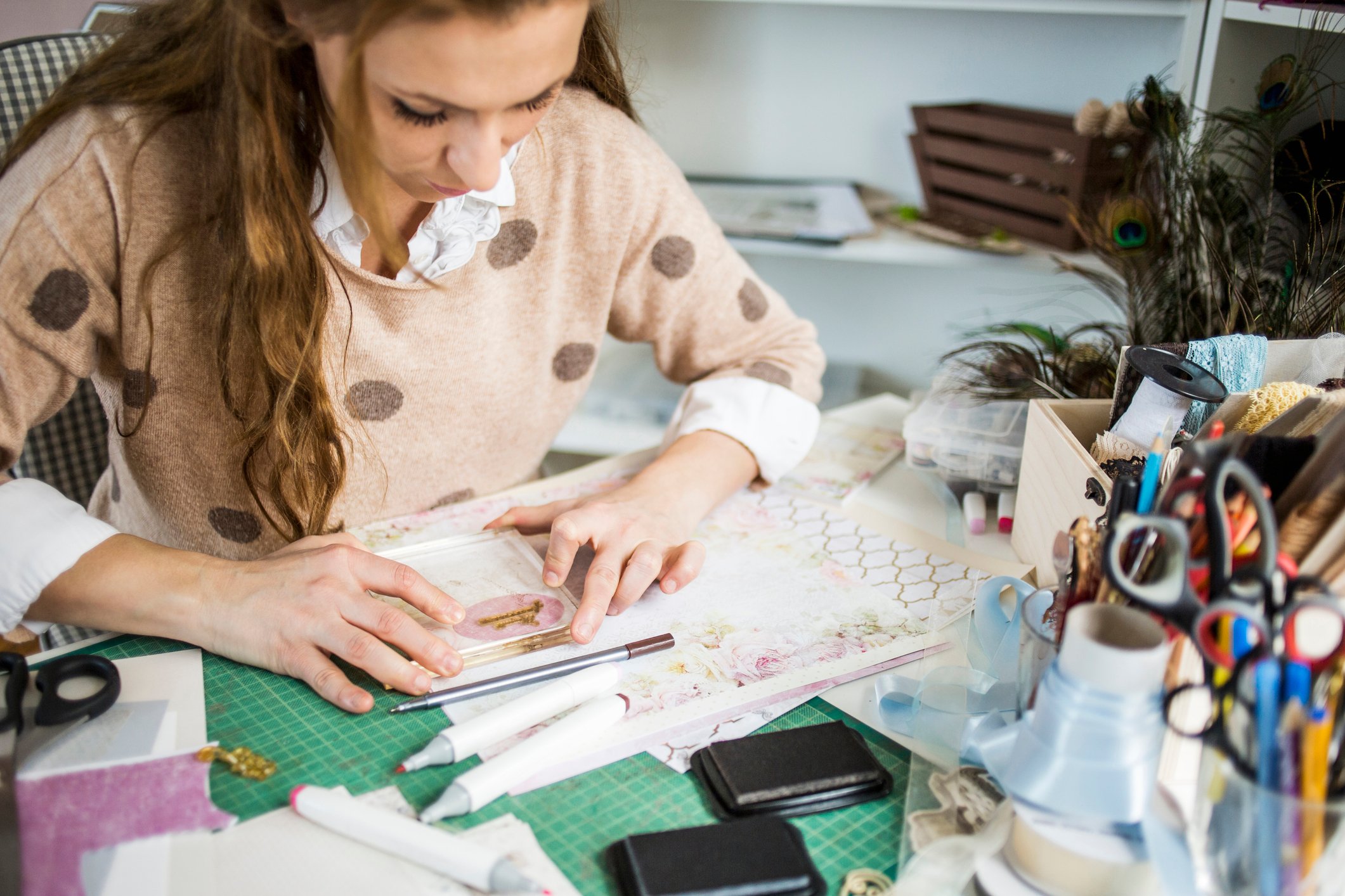 Young woman making handmade cards in her atelier, small business owner