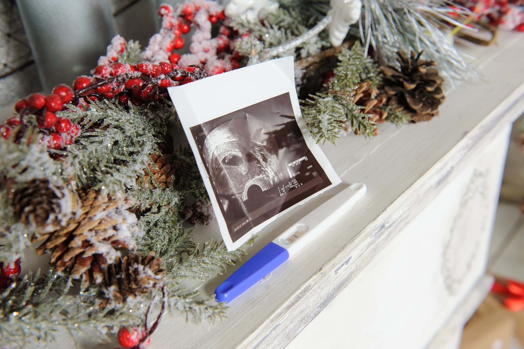 ultrasound picture and a pregnancy test with Christmas decor. close-up.